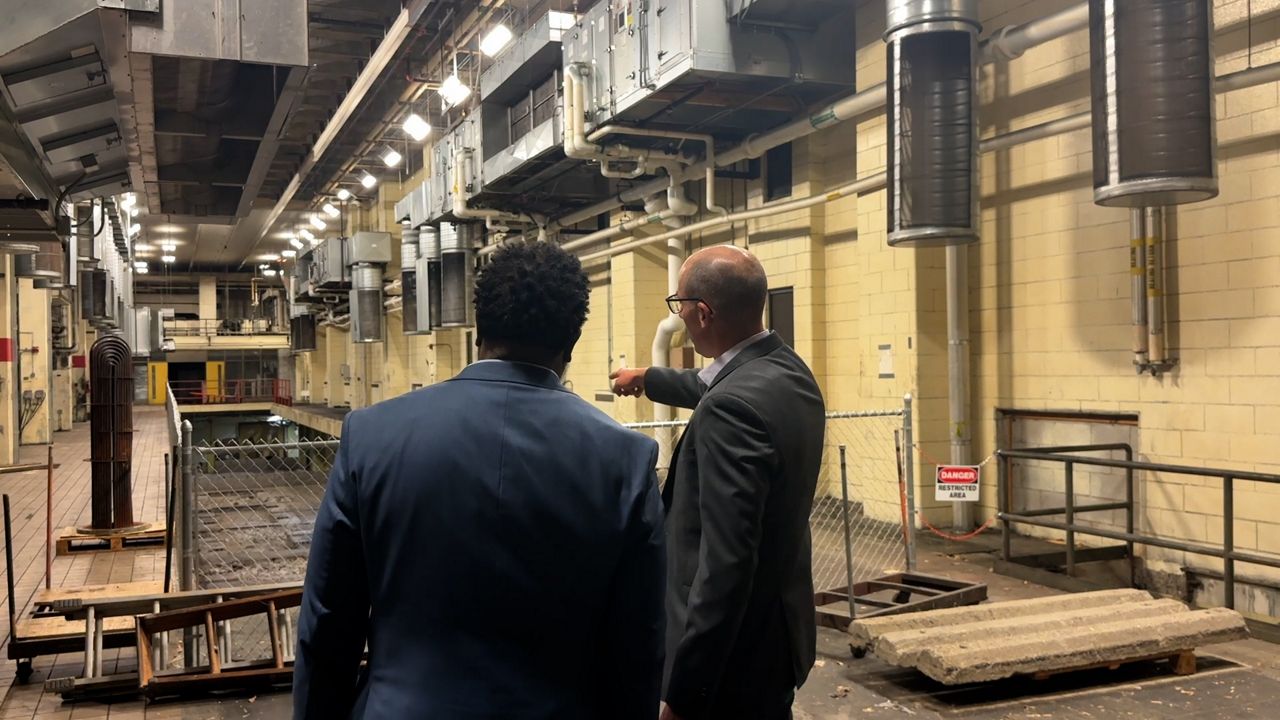 Youngstown Mayor Tito Brown stands with Alexander Steeb the Operations Director of America Makes in the future home of the Youngstown Innovation Hub for Aerospace and Defense
