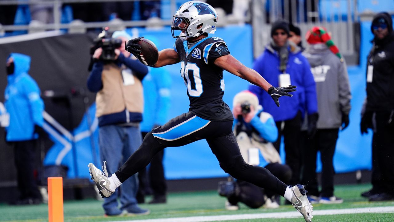 Carolina Panthers running back Chuba Hubbard scores the winning touchdown against the Arizona Cardinals during overtime in an NFL football game Sunday, Dec. 22, 2024, in Charlotte, N.C. (AP Photo/Rusty Jones)