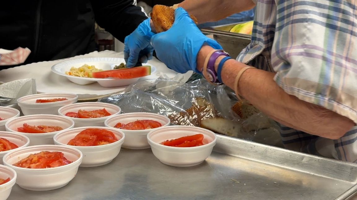 Volunteers at Faith Baptist Community Center plate hot meals to serve to their neighbors
