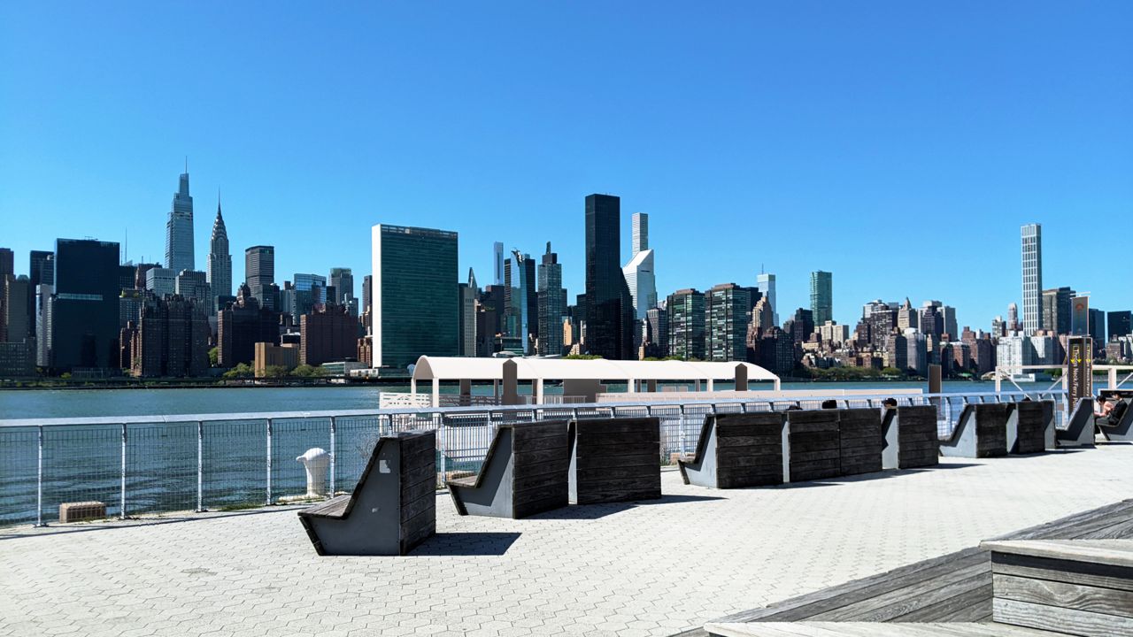 View of Manhattan skyline with East River in front and rendering of new terminal with no vessels