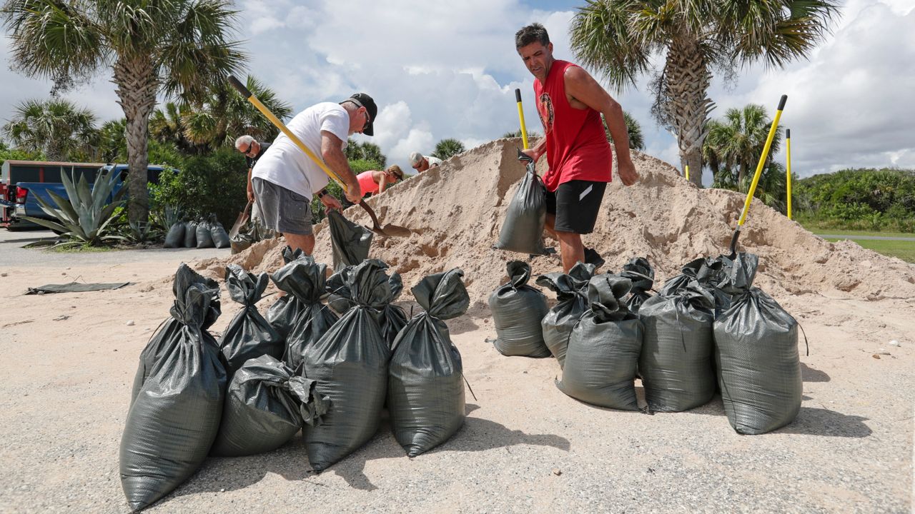 Residents prepare for Hurricane Dorian by grabbing sand ahead of its approach. (Spectrum News)