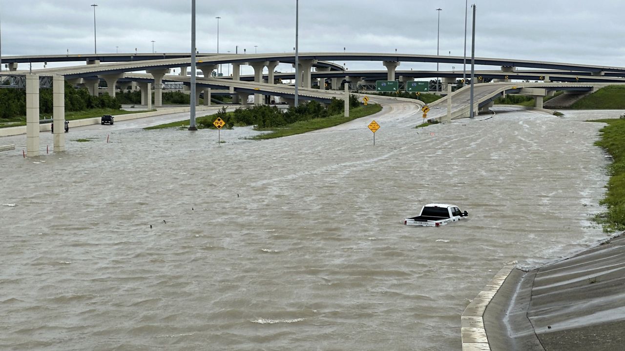 A vehicle is stranded in high waters on a flooded highway in Houston, on Monday, July 8, 2024, after Beryl came ashore in Texas as a hurricane and dumped heavy rains along the coast. (AP Photo/Juan A. Lozano)