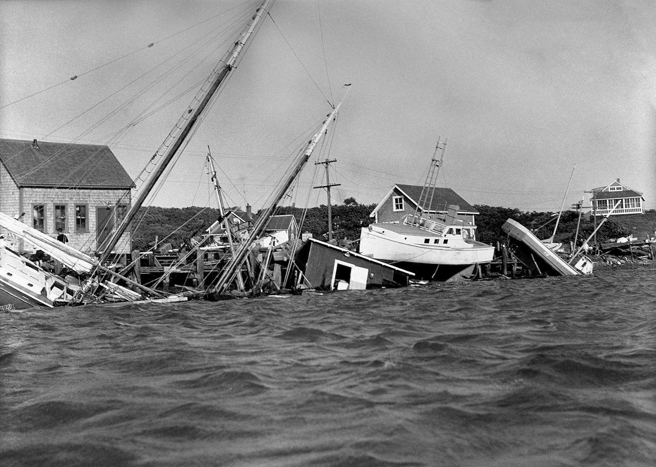 This Aug. 31, 1954 file photo shows boats driven up onto docks and buildings, and knocked into the water in the Menemsha section of Martha's Vineyard as a howling Hurricane Carol accompanied by fiercely driving rain struck New England causing millions of dollars of damage. (AP Photo/DCG)