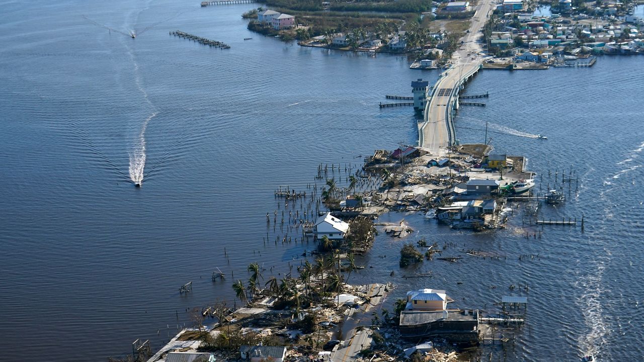 The bridge leading from Fort Myers to Pine Island, Fla. is heavily damaged in the aftermath of Hurricane Ian on Saturday, Oct. 1, 2022.