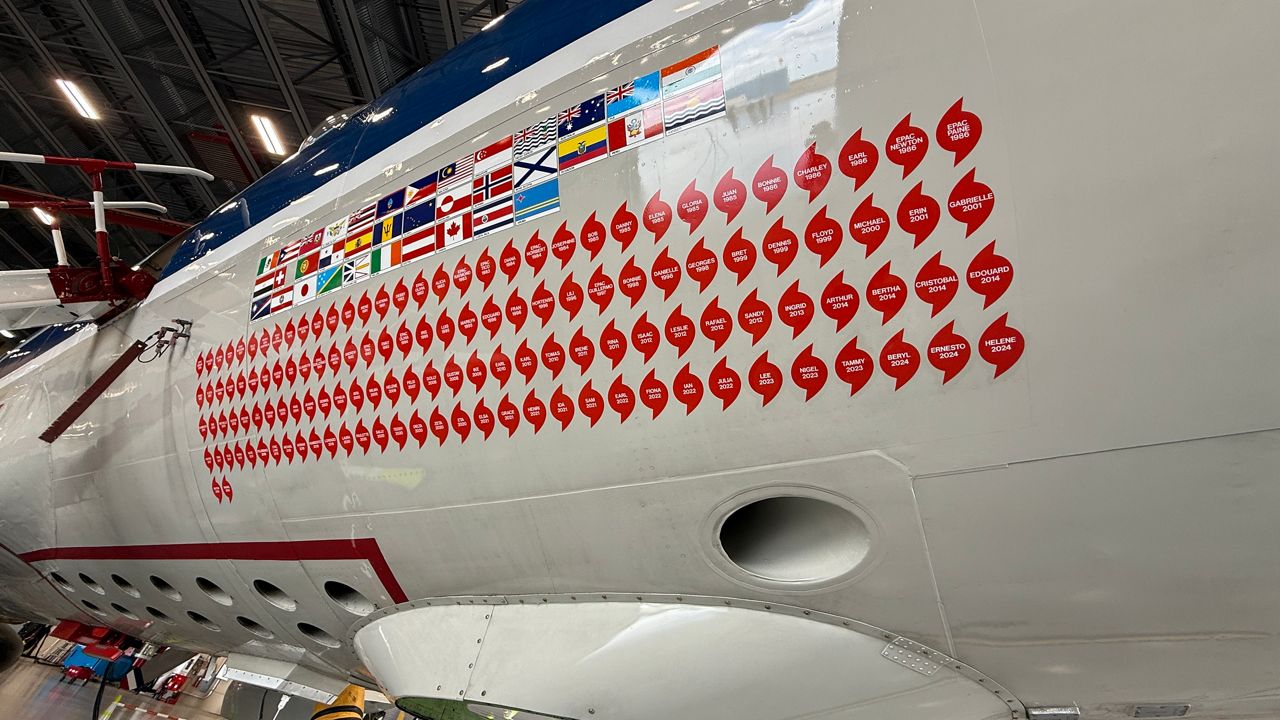 Stickers line the WP3D Orion Aircraft, denoting each named storm the aircraft has flown inside. (Spectrum News/Erin Murray)