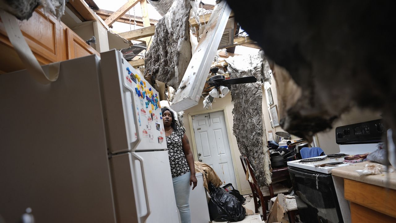 Natasha Ducre surveys the kitchen of her devastated home, which lost most of its roof during the passage of Hurricane Milton, in Palmetto, Fla., Thursday, Oct. 10, 2024. (AP Photo/Rebecca Blackwell)