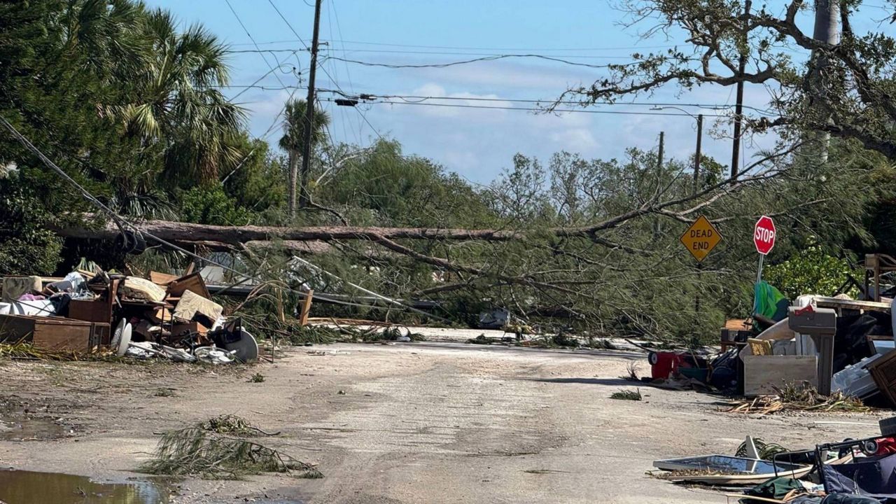 A downed tree and piles of debris line the roads in Holmes Beach following Hurricane Milton. (Photo: Holmes Beach Police Department)