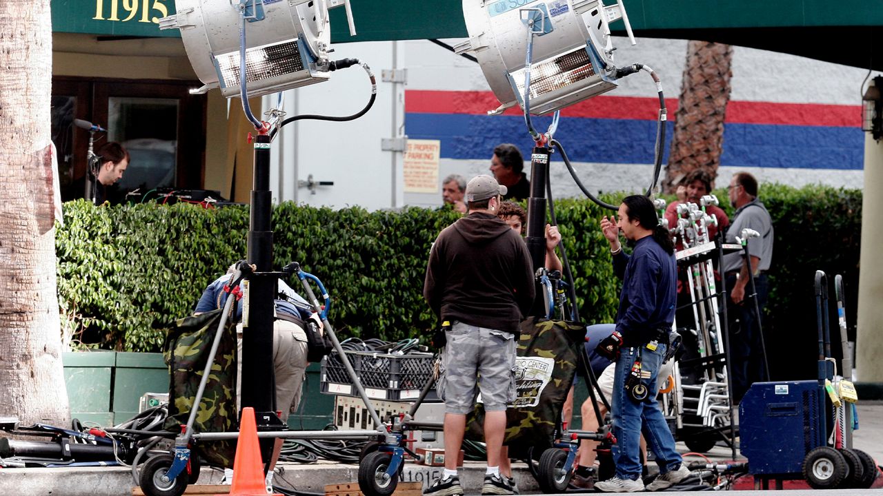 In this Nov. 5, 2007 file photo, a production crew works on a film set along Ventura Blvd. near to CBS Studios in the Studio City section of Los Angeles. (AP Photo/Richard Vogel, file)