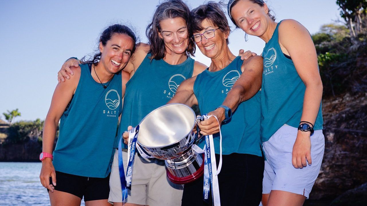 The University of South Florida rowing team — also known as "Salty Science" — smiles at the trophy they won competing in the World's Toughest Row-Atlantic. (Photo courtesy of USF)