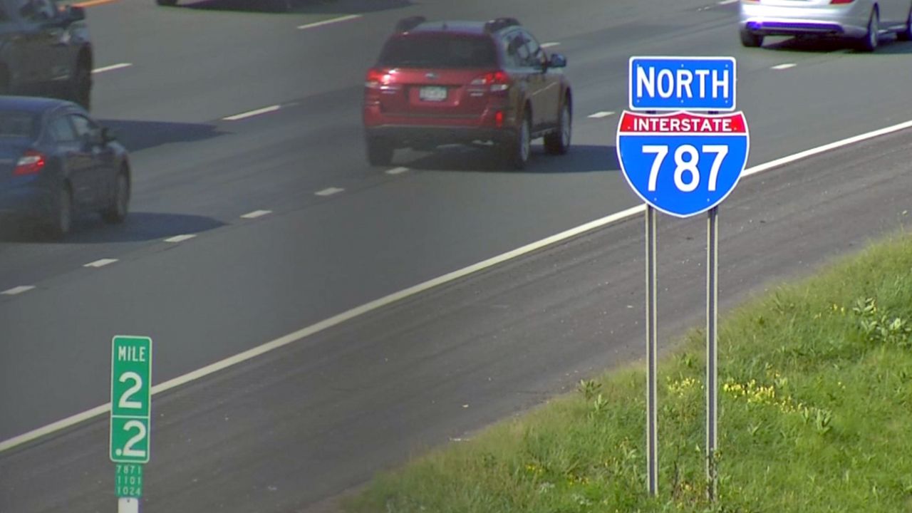 route 787 north sign with cars driving by in background