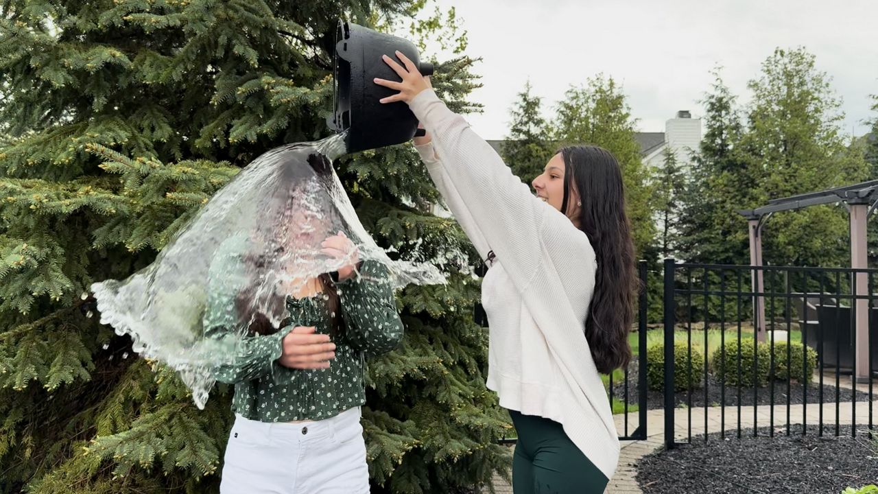 Layla Macias dumping water on Lucy Cho for the new ice bucket challenge.