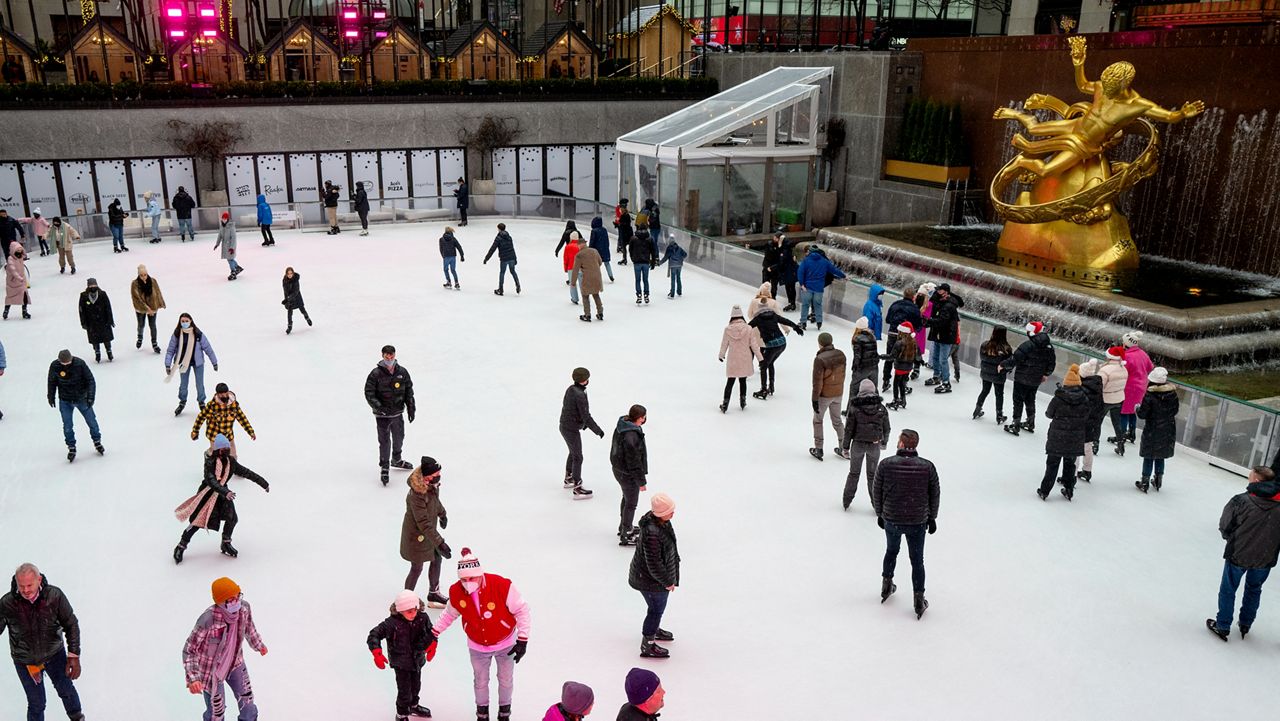 People ice skate as they take part in traditional Christmas Day activities as they gather at Rockefeller Center on Saturday, Dec. 25, 2021 in New York.