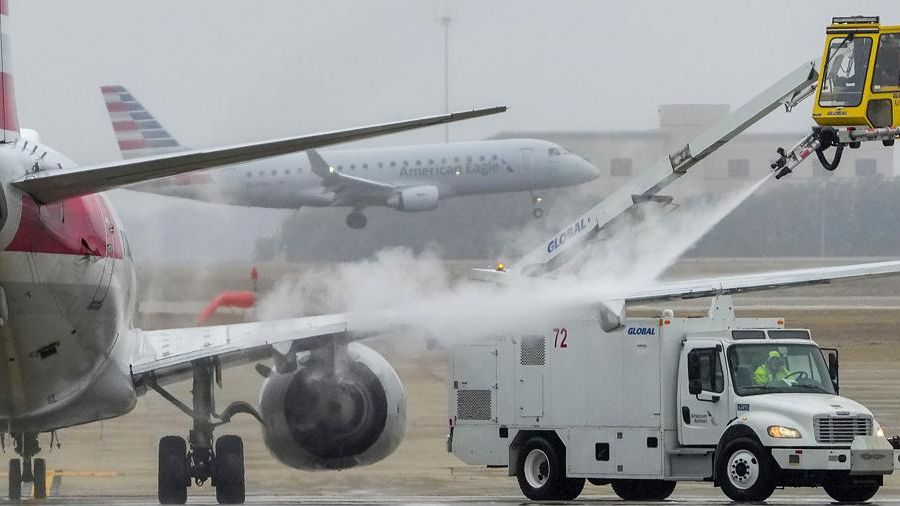 An American Airlines aircraft undergoes deicing procedures on Monday, Jan. 30, 2023, at Dallas/Fort Worth International Airport in Texas. (Lola Gomez/The Dallas Morning News via AP)