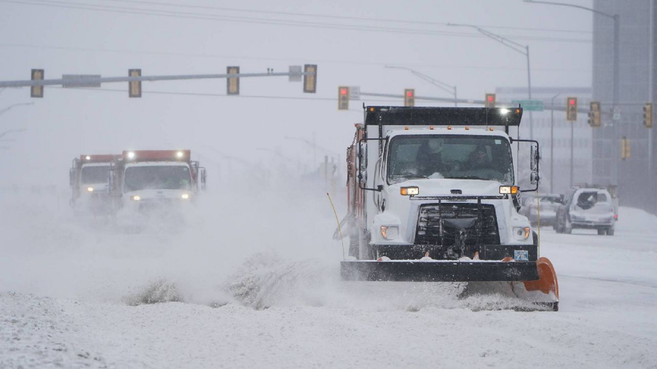 Snowplows works to clear the road during a winter storm Sunday, Feb. 14, 2021, in Oklahoma City. Snow and ice blanketed large swaths of the U.S. on Sunday, prompting canceled flights, making driving perilous and reaching into areas as far south as Texas’ Gulf Coast. (AP Photo/Sue Ogrocki)