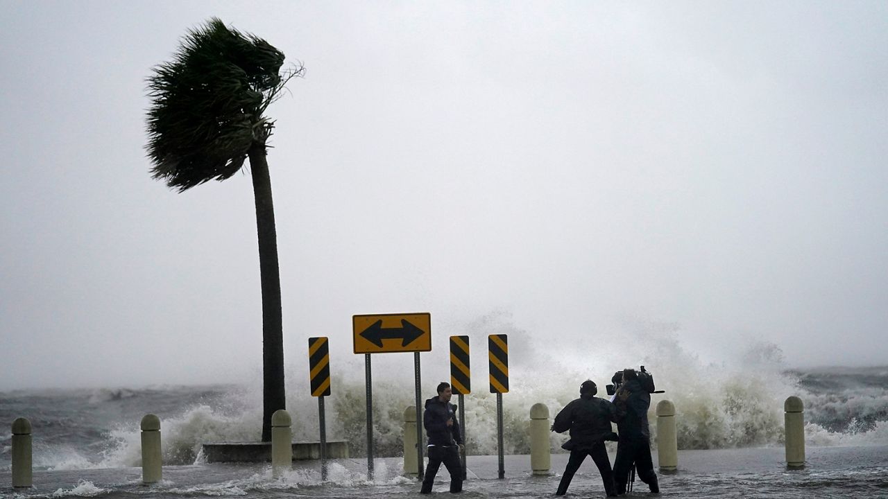 A news crew reports on the edge of Lake Pontchartrain ahead of approaching Hurricane Ida in New Orleans. (AP/Gerald Herbert)