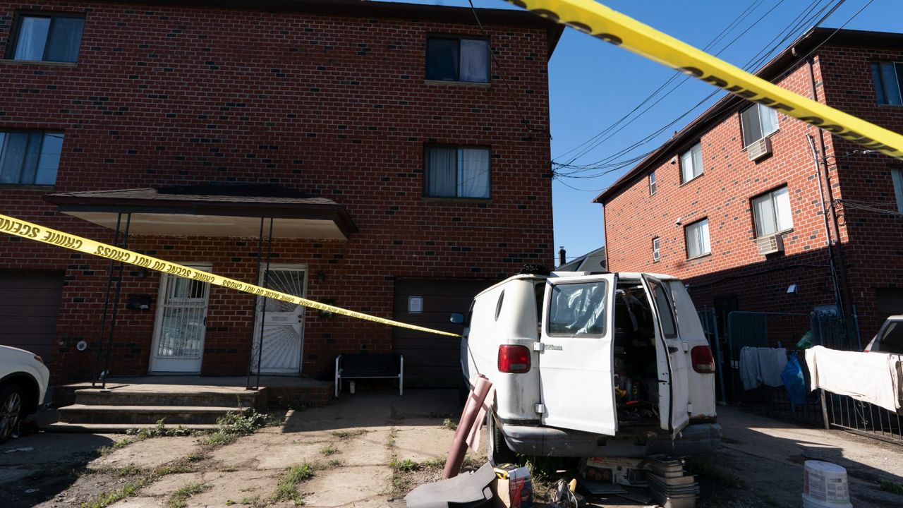 Police tape cordons off a home where three people died in a basement apartment flooded during a historic downpour caused by the remnants of Hurricane Ida, Sept. 3, 2021. (AP Photo/Mark Lennihan)