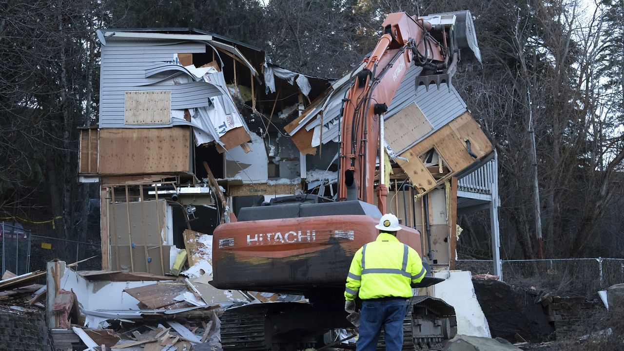 Heavy equipment is used to demolish the house where four University of Idaho students were killed in 2022 on Thursday, Dec. 28, 2023, in Moscow, Idaho. (AP Photo/Ted S. Warren)