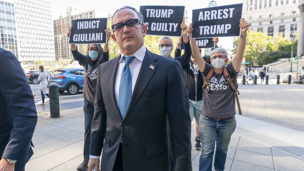 Activists follow Igor Fruman as he arrives Friday in federal court in New York. (AP Photo/Mary Altaffer)