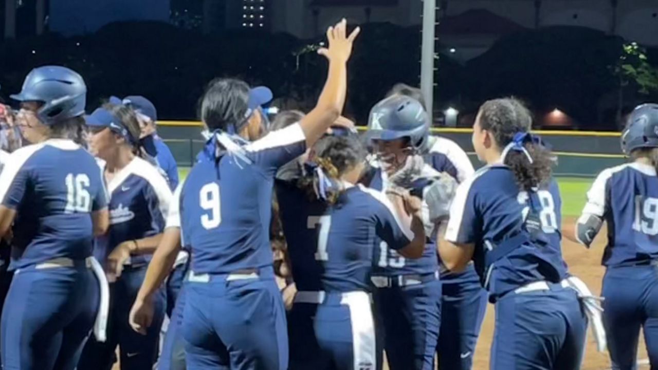 Kamehameha players mobbed Nevaeh Telles (15) after her three-run homer in the fourth inning against Maryknoll on Wednesday. 