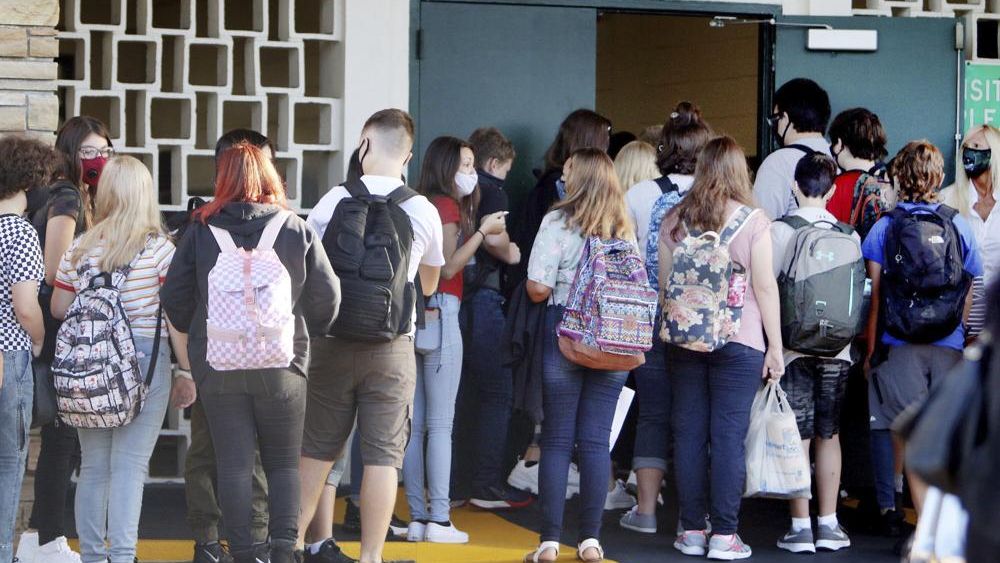 FILE - Students enter Gulf Middle School during the first day of school for Pasco County Schools in New Port Richey, Fla., in this Monday, Aug. 24, 2020, file photo. (Douglas R. Clifford/Tampa Bay Times via AP, File)