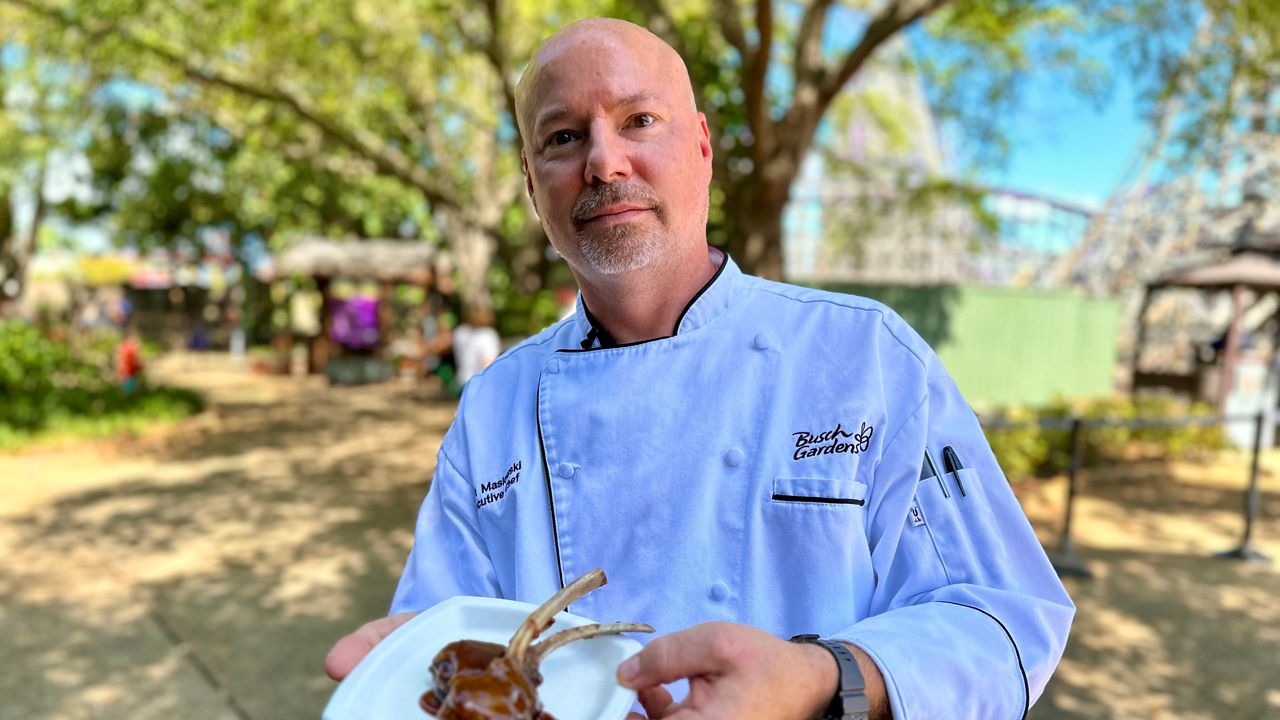 Busch Gardens Executive Chef Matt Maslowski shows the lamb offering, just one of numerous dishes available at the park's Food and Wine Festival, which runs weekends through May 21. (Spectrum News/Bobby Collins)