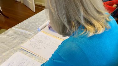 Susan Reynolds works on a birth chart. 