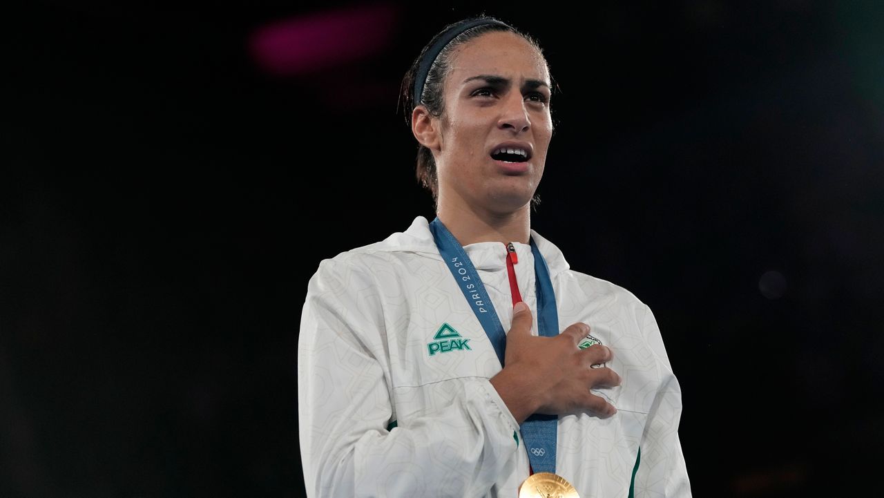 Gold medalist Algeria's Imane Khelif poses during a medals ceremony for the women's 66 kg final boxing match at the 2024 Summer Olympics, Friday, Aug. 9, 2024, in Paris, France. (AP Photo/Ariana Cubillos)