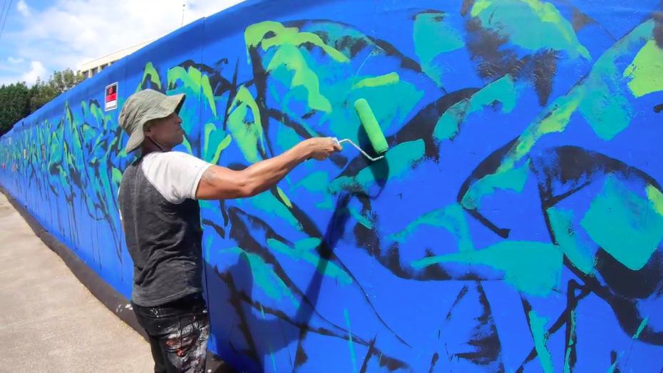 Native Hawaiian artist Solomon Enos painted a mural showing loʻi on the fence around the construction site of the new $170-million Residences for Graduate Students project on the UH Mānoa campus. (Courtesy UH Manoa)