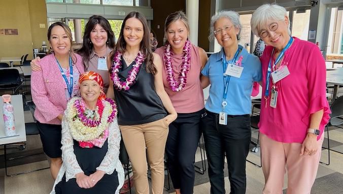 Susan Hirano (sitting) with UH Cancer Center staff at the launch event. (Photo courtesy of the University of Hawaii)