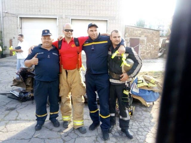 Joe Elliott (red shirt) poses for a photo with firefighters in Ukraine during a mission trip in 2019. (Photo courtesy of Joe Elliott)