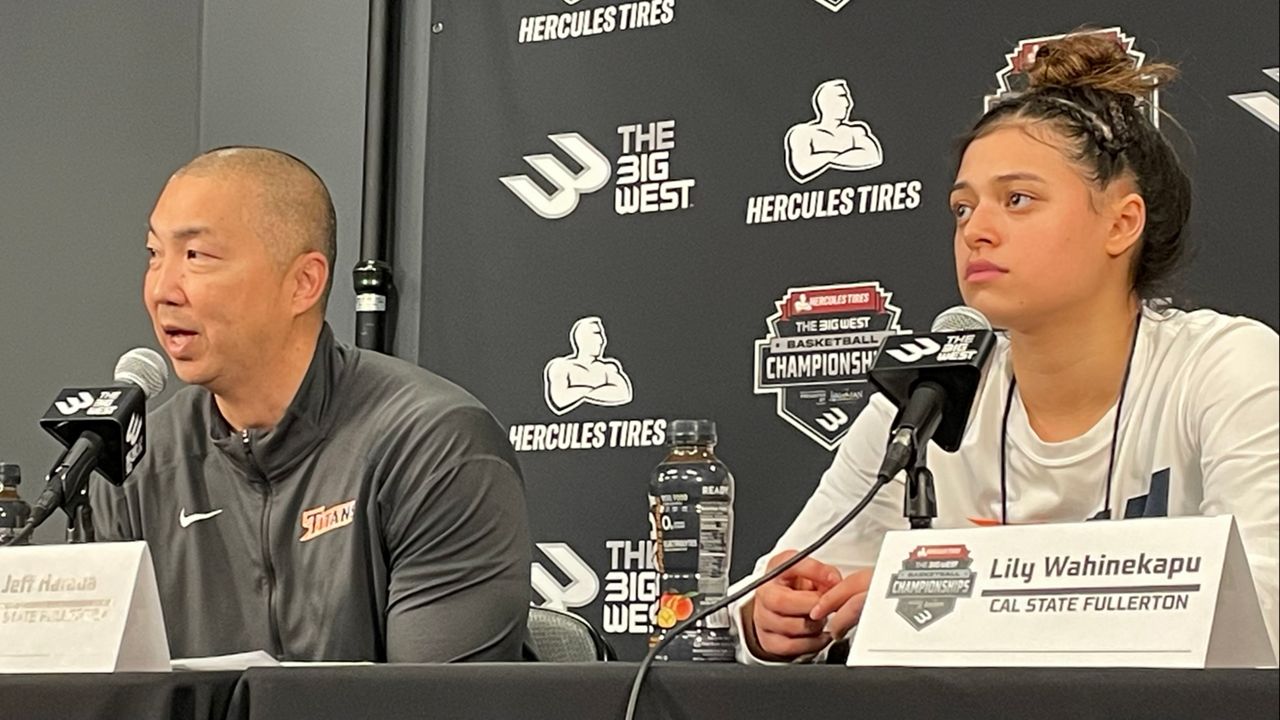 Cal State Fullerton coach Jeff Harada spoke to media next to freshman guard Lily Wahinekapu after the Titans' quarterfinal loss to UC Irvine on Wednesday.