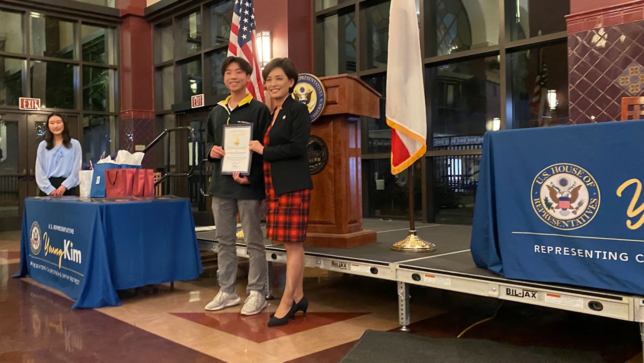 Rep. Young Kim, R-Calif., awards first place to Hudson Kaleb Dy for his app on an affordable crowd funded early warning system to detect earthquakes (William D'Urso/Spctrum News)