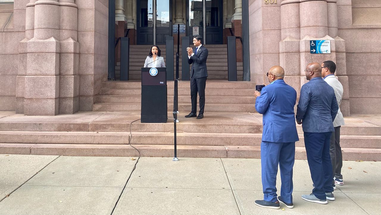 Dozens of city employees and community leaders attended the formal announcement of Sheryl Long as Cincinnati's next city manager. Here, Long is being introduced by Mayor Aftab Pureval as members of her family look on. (Casey Weldon/Spectrum News 1)