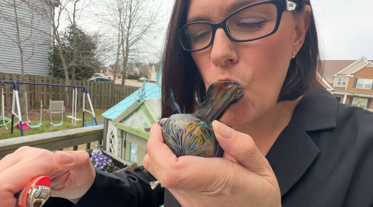 Corey Stahl smokes hemp (Evan Sery/Spectrum News 1)