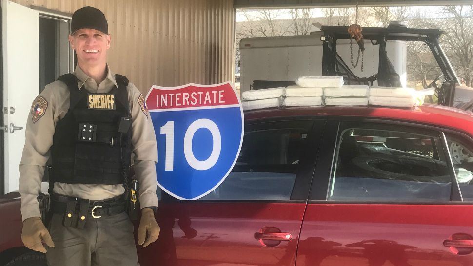 The Fayette County Sheriff's Office's Drug Interdiction Investigator David Smith poses with the roughly $1 million in cocaine he seized on Jan. 25, 2018. (Source: Fayette County Sheriff's Office)