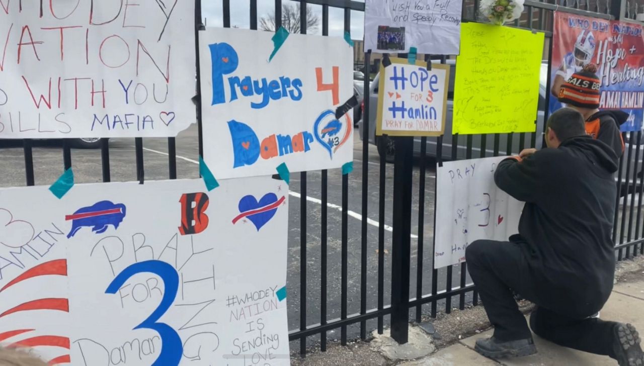 Fans left signs and lit candles outside UC Medical Center to show support for Damar Hamlin. Hall feels people want to do 'whatever they can' to show support. (Photo courtesy of Madeline Hall)