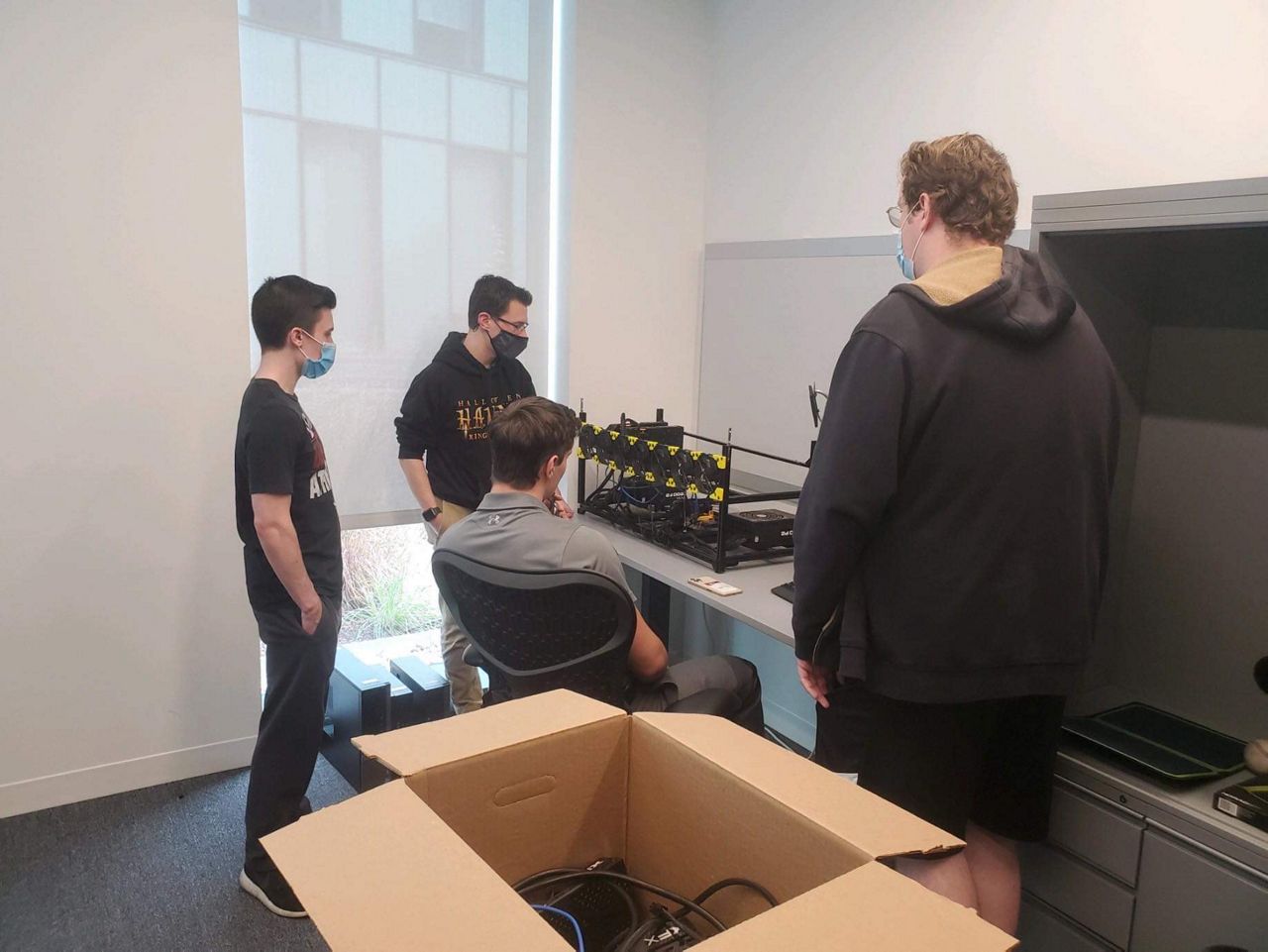 University of Cincinnati students looking at their new project.