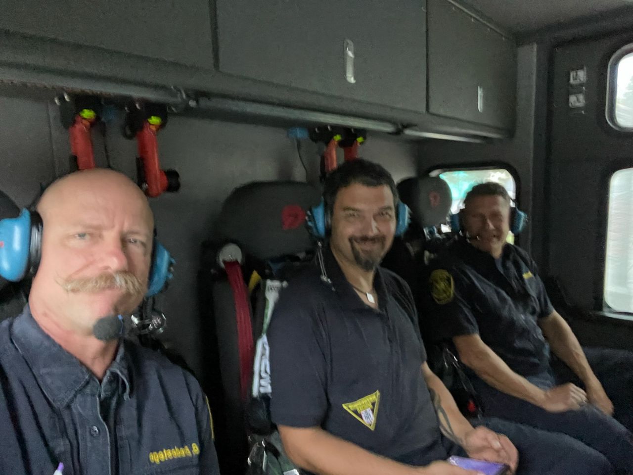 Firefighter Jan Hamacher rides in the back of a fire engine as part of a three-week exchange program between Cincinnati and Munich, Germany. (Photo courtesy of Cincinnati Fire Department)