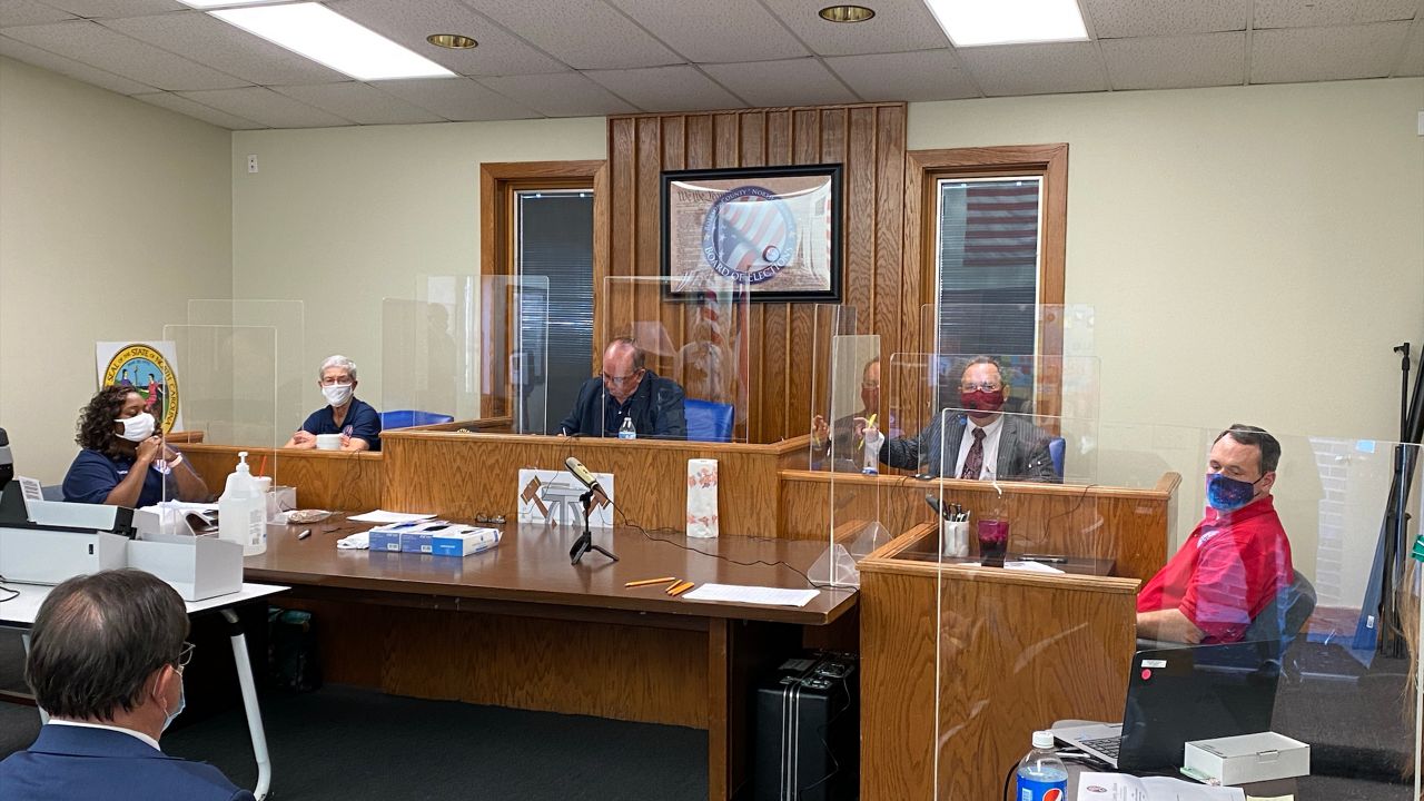 Robeson County officials work on ballot canvassing Monday afternoon. The county pushed back its canvass after officials discovered they didn't tally nearly 2,000 early votes.