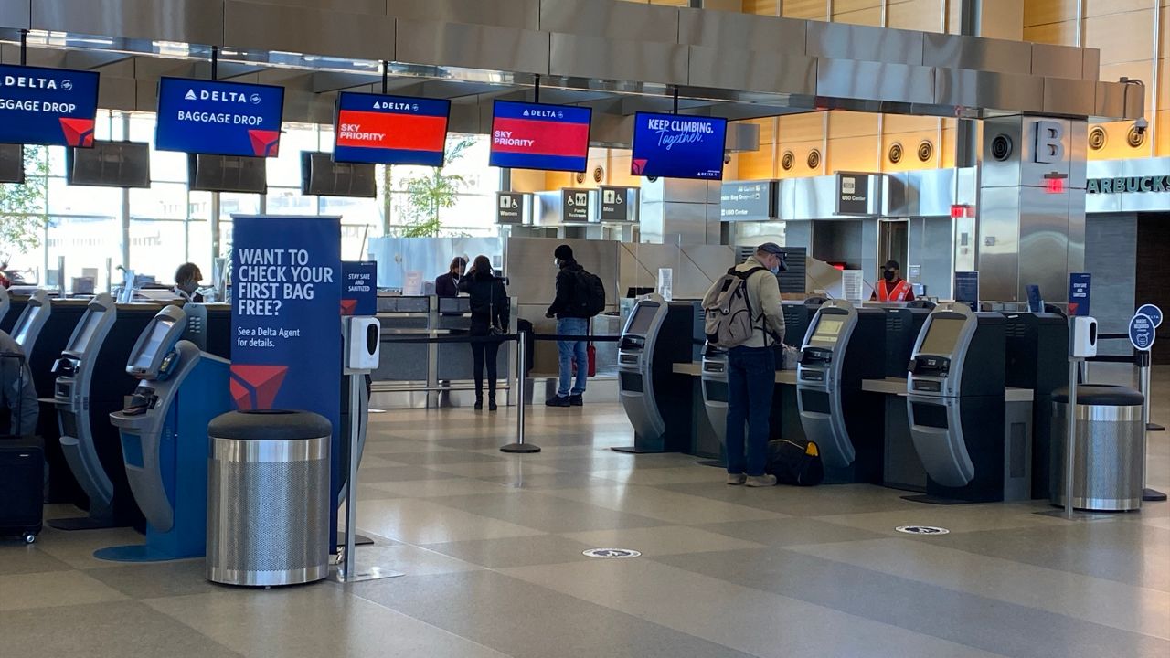 Travelers check in at Raleigh-Durham International Airport. Officials there say they will monitor foot traffic this week to see if they need to make adjustments for the later holidays.