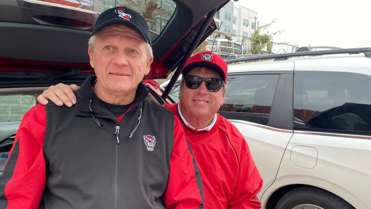 Former N.C. State football player Nathan Ritter, left, and his cousin Stuart Stout attend the Duke's Mayo Bowl at Bank of America Stadium in Charlotte on Friday. (Spectrum News 1/Estephany Escobar)