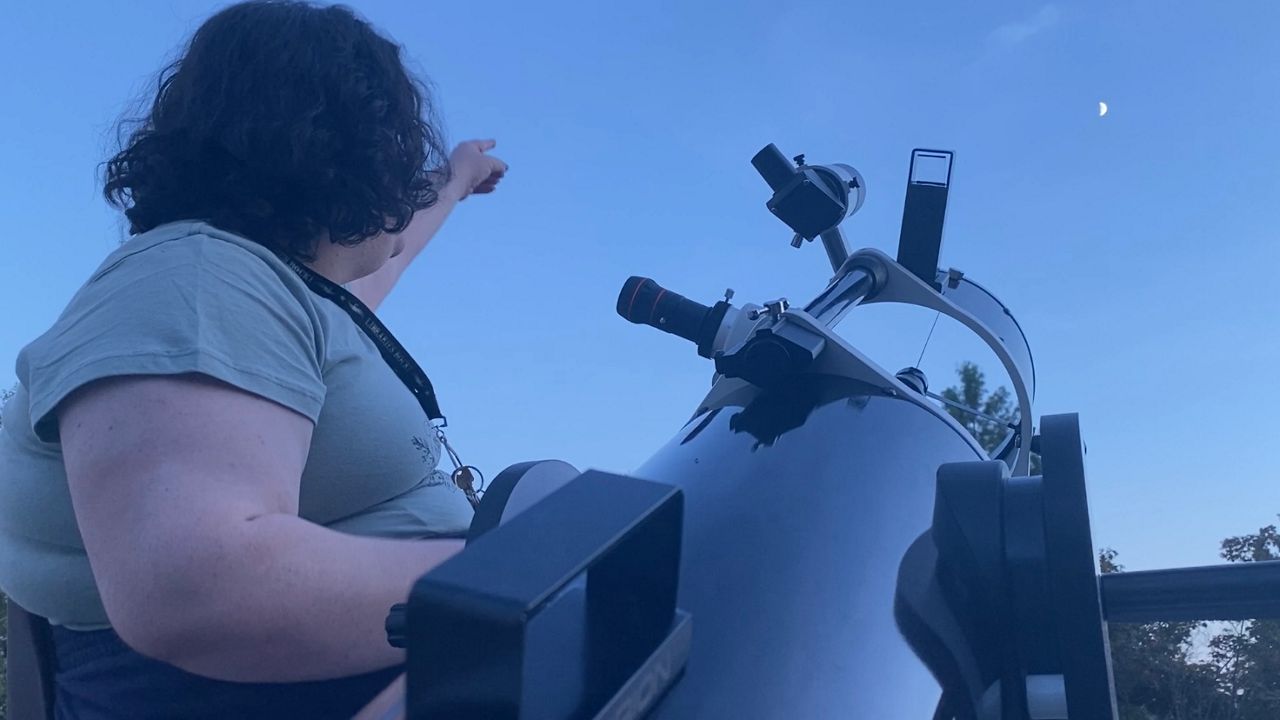 Luna Brannon watches the evening sky during an observing session at the Cline Observatory in Greensboro. 