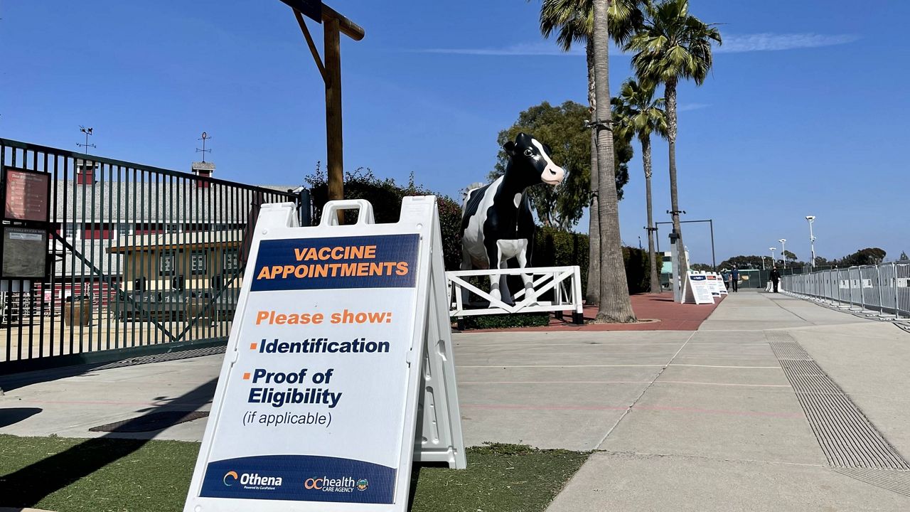 A sign in front of a vaccination super site at the Orange County fairground in Costa Mesa alerts people of what they will need for their appointment. April 8, 2021 (Paco Ramos-Moreno/ Spectrum News 1)