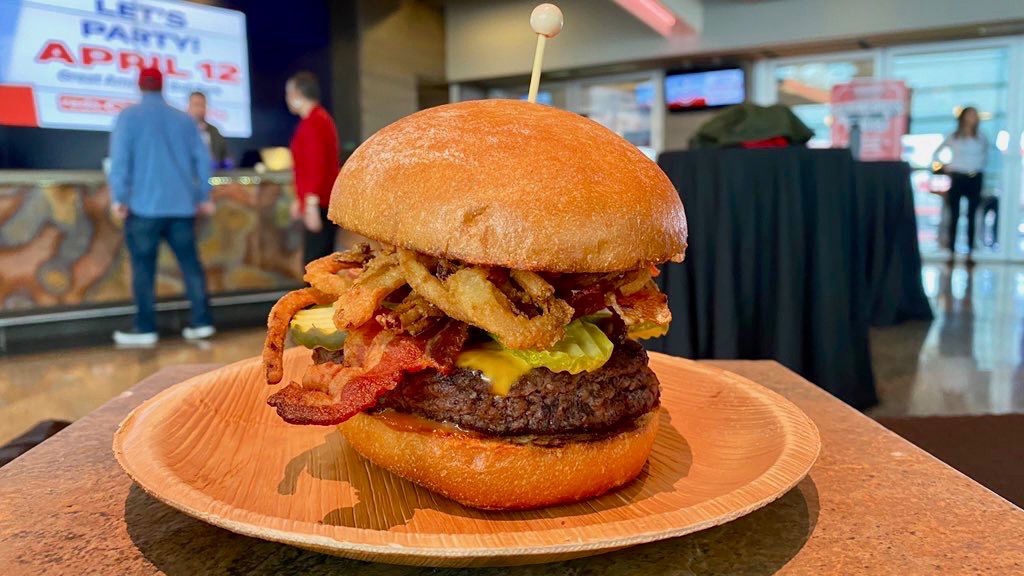 The new menu also features some traditional items, like this handcrafted burger covered in cheese, bacon, onion straws and BBQ sauce. (Casey Weldon/Spectrum News 1)