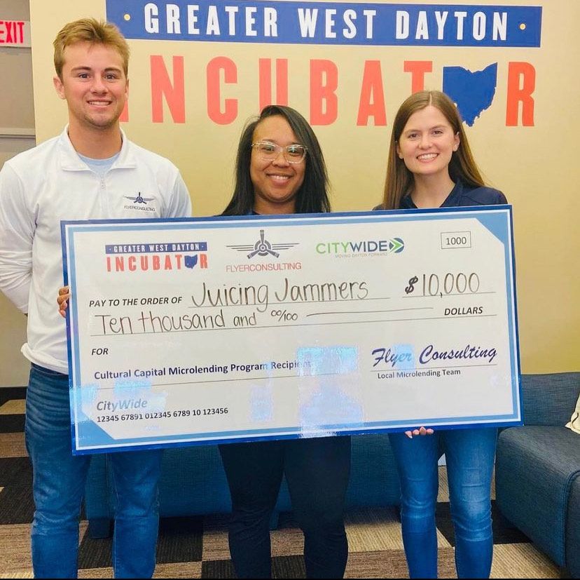 Juicing Jammers owner Tawnni Miles poses with team members at the Greater West Dayton Incubator after being awarded a $10,000 microloan.  (Photo Credit: Greater West Dayton Incubator)