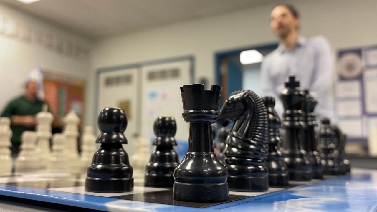 Grandmaster Gabriel Flom explains chess to students at B'nai Shalom Day School in Greensboro. (Spectrum News 1/Noelle Lashley)