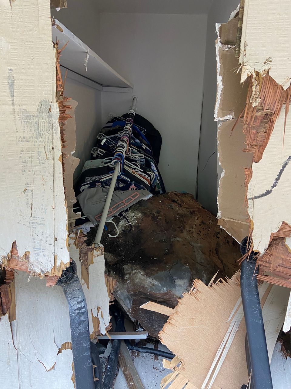 A boulder crashes through a wall and into an Aiea home