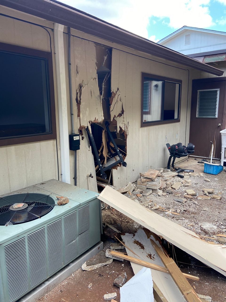 A boulder crashes through a wall and into an Aiea home