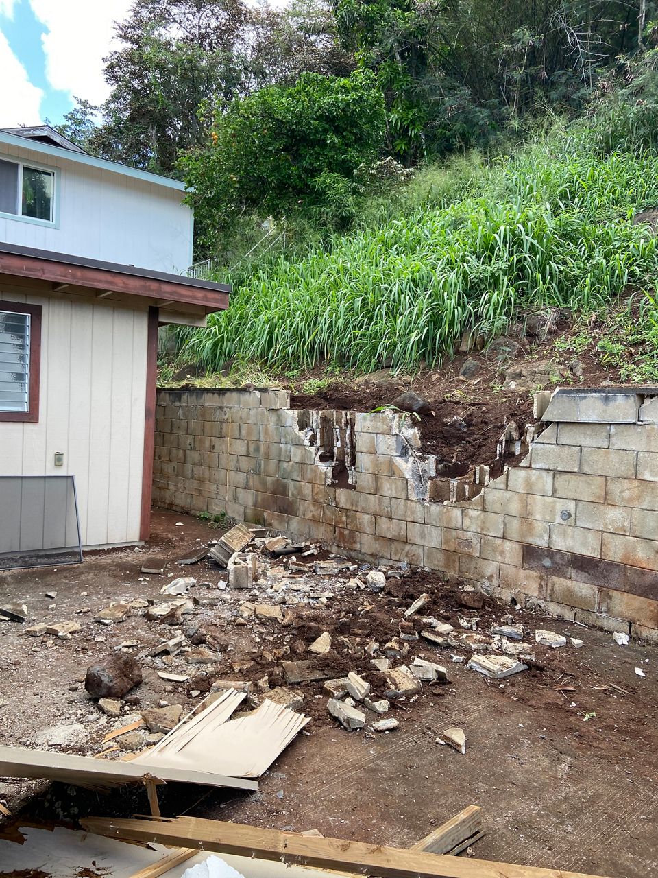A boulder crashes through a wall and into an Aiea home