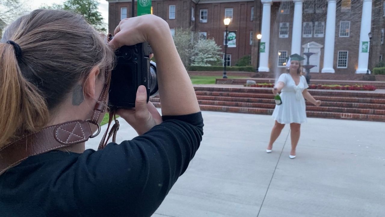 Sara Gibson takes a picture of a new college graduate's celebration. 